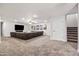 Spacious basement with a huge sectional couch and carpet flooring at 2107 E Park Ave, Gilbert, AZ 85234