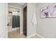 Bathroom featuring a shower with a decorative curtain and a storage cabinet at 2107 E Park Ave, Gilbert, AZ 85234
