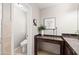 Bathroom with a marble vanity, decorative mirror, framed art, and a modern toilet with a soft-close lid at 2107 E Park Ave, Gilbert, AZ 85234