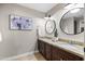 Bathroom with dual sinks, decorative mirrors, and stylish accents at 2107 E Park Ave, Gilbert, AZ 85234