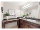 Spacious bathroom with a dark vanity, large mirror, and decorative accents at 2107 E Park Ave, Gilbert, AZ 85234