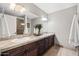Spacious bathroom with double vanity sinks, a large mirror, and a separate shower and toilet room at 2107 E Park Ave, Gilbert, AZ 85234