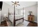 Charming primary bedroom with a four-poster bed, hardwood floors, and ample natural light at 2107 E Park Ave, Gilbert, AZ 85234