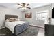 Cozy bedroom featuring a comfortable bed, decorative rug, and large window at 2107 E Park Ave, Gilbert, AZ 85234