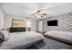 Large bedroom with two beds, a TV, and a view into an ensuite bathroom at 2107 E Park Ave, Gilbert, AZ 85234