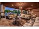 Luxury covered patio showcases stylish furnishings, stone flooring, and a view of the beautiful pool area at 2107 E Park Ave, Gilbert, AZ 85234
