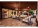 Elegant covered patio with stylish seating, fireplace, and seamless indoor-outdoor living at 2107 E Park Ave, Gilbert, AZ 85234