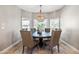 This dining room features neutral walls, a decorative chandelier, and views from the windows at 2107 E Park Ave, Gilbert, AZ 85234