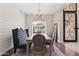 Dining room featuring a chandelier, accent wall, and decorative iron door at 2107 E Park Ave, Gilbert, AZ 85234