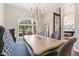 Dining room featuring a chandelier, dining table, and decorative iron door at 2107 E Park Ave, Gilbert, AZ 85234