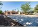 Spacious driveway and garage with ample parking, complemented by a basketball hoop and trampoline at 2107 E Park Ave, Gilbert, AZ 85234