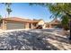 Wide driveway featuring a stone and stucco home with multiple garages and a tile roof at 2107 E Park Ave, Gilbert, AZ 85234
