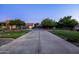 Long driveway leading to garages and a beautifully landscaped front yard at 2107 E Park Ave, Gilbert, AZ 85234
