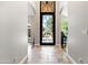 Foyer with decorative iron door, tile floors, and arched doorways at 2107 E Park Ave, Gilbert, AZ 85234