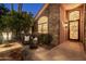 Covered entryway with stone exterior and outdoor seating area at 2107 E Park Ave, Gilbert, AZ 85234