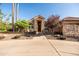 Charming stone home with a unique arched entryway, mature trees, and a well-manicured lawn at 2107 E Park Ave, Gilbert, AZ 85234