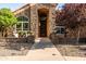 Inviting front porch featuring stone accents, a sitting area, and a charming water feature at 2107 E Park Ave, Gilbert, AZ 85234
