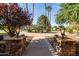 Stone entryway and lush front yard with mature trees lead up to the house at 2107 E Park Ave, Gilbert, AZ 85234