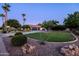 Expansive front lawn and mature trees offer serene curb appeal at 2107 E Park Ave, Gilbert, AZ 85234