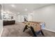 Brightly lit game room showing a foosball table and a view into the living room at 2107 E Park Ave, Gilbert, AZ 85234