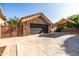 Attached garage with stone accents and a wide driveway for ample parking at 2107 E Park Ave, Gilbert, AZ 85234