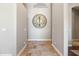 Hallway with travertine floors and a decorative clock at 2107 E Park Ave, Gilbert, AZ 85234