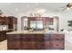 Spacious kitchen features an oversized island, custom cabinets, granite counters, stainless steel fridge and modern appliances at 2107 E Park Ave, Gilbert, AZ 85234
