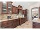 Granite kitchen counter with custom wood cabinets, stone backsplash and stainless steel appliances at 2107 E Park Ave, Gilbert, AZ 85234