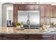 Close-up on a kitchen island showcases granite countertop, custom cabinets, stainless steel fixtures and appliances at 2107 E Park Ave, Gilbert, AZ 85234