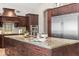 Close-up of kitchen island featuring granite countertops, custom wood cabinets and drawers, and stainless steel appliances at 2107 E Park Ave, Gilbert, AZ 85234