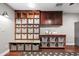 Custom laundry room cabinets with open shelving, ample storage space, and countertops for folding at 2107 E Park Ave, Gilbert, AZ 85234
