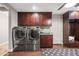 Bright laundry room featuring stainless steel washer and dryer with plenty of storage and a folding counter at 2107 E Park Ave, Gilbert, AZ 85234