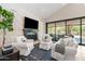 Comfortable living room featuring a fireplace, white couches, and sliding doors to the patio at 2107 E Park Ave, Gilbert, AZ 85234