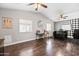 Spacious living room with hardwood floors, a high ceiling, and a black and white accent wall at 2107 E Park Ave, Gilbert, AZ 85234