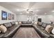 Expansive living room featuring a huge sectional sofa and movie posters, perfect for entertaining guests at 2107 E Park Ave, Gilbert, AZ 85234