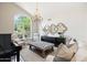 Bright living room with a large arched window, chandelier, and stylish decor at 2107 E Park Ave, Gilbert, AZ 85234