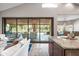 Living room view to outdoor patio and kitchen featuring travertine floors, granite countertops and plenty of natural light at 2107 E Park Ave, Gilbert, AZ 85234