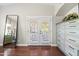 Bedroom with hardwood floors, French doors and a full-length mirror at 2107 E Park Ave, Gilbert, AZ 85234