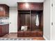 Mudroom with custom built-in storage cabinets, open shelving, and bench seating for organization at 2107 E Park Ave, Gilbert, AZ 85234
