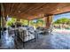 Inviting outdoor living space featuring a fireplace, comfortable seating, and a view of the pool at 2107 E Park Ave, Gilbert, AZ 85234