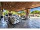 Inviting outdoor living space featuring a fireplace, comfortable seating, and a view of the pool at 2107 E Park Ave, Gilbert, AZ 85234