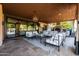 Inviting outdoor living space featuring a fireplace, comfortable seating, and a view of the pool at 2107 E Park Ave, Gilbert, AZ 85234