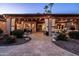 Rear patio features a covered entertaining area, travertine flooring, and meticulous desert landscaping at 2107 E Park Ave, Gilbert, AZ 85234