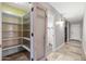 Walk in pantry featuring open shelving and a view to the hallway at 2107 E Park Ave, Gilbert, AZ 85234