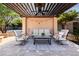 Outdoor seating beneath a wood pergola with overhead fan and string lights provides a relaxing ambiance at 2107 E Park Ave, Gilbert, AZ 85234