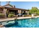Outdoor living is extended by this beautiful pool and covered patio with outdoor dining and fireplace at 2107 E Park Ave, Gilbert, AZ 85234
