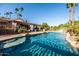 Sparkling pool with rock features, waterfall, and professional landscaping creates a serene backyard retreat at 2107 E Park Ave, Gilbert, AZ 85234