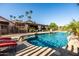 Backyard pool with rock features, covered patio, and lounge chairs that enhance the outdoor living space at 2107 E Park Ave, Gilbert, AZ 85234