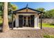 Backyard shed with black trim and wreath-adorned doors offers a unique space for hobbies or relaxation at 2107 E Park Ave, Gilbert, AZ 85234