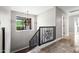 Second story landing with views to the outside and a decorative chandelier over looking stairs at 2107 E Park Ave, Gilbert, AZ 85234